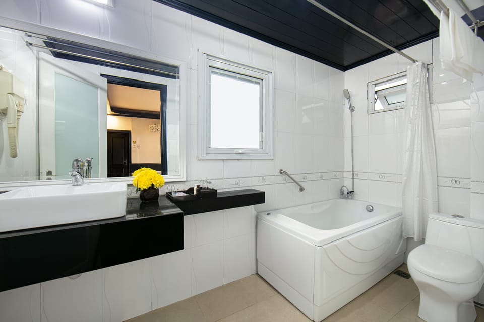 Hydromassage showerhead, designer toiletries, hair dryer, slippers