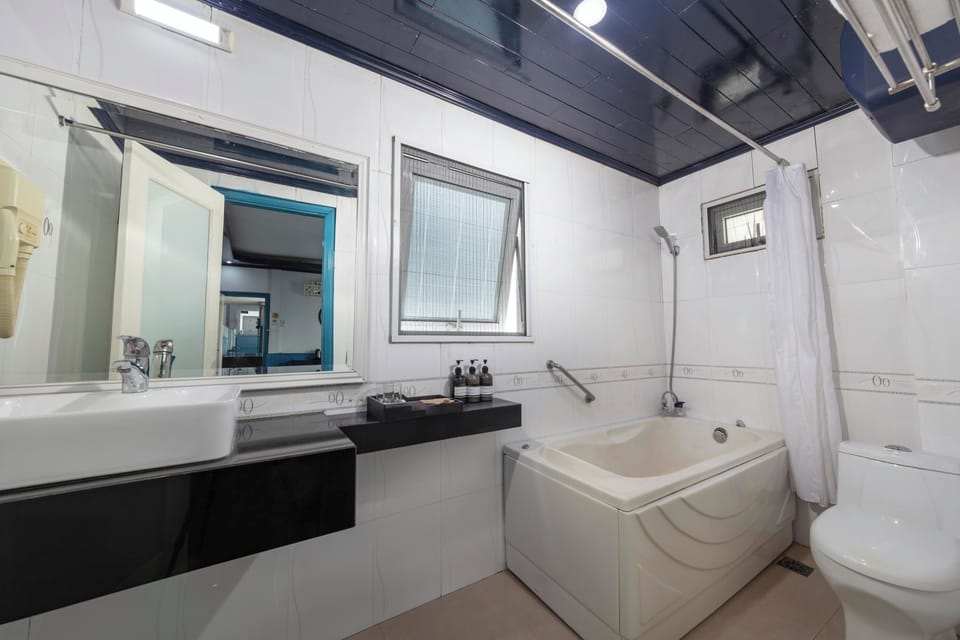 Hydromassage showerhead, designer toiletries, hair dryer, slippers
