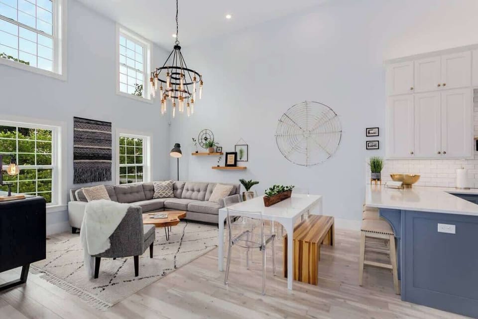 The living room flows perfectly into the kitchen. With plenty of extra seating around the living space, dining table, and bar this is the perfect open space for entertaining.