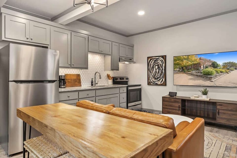 From the bedroom, enjoy the view of the home's 65-inch Smart TV.