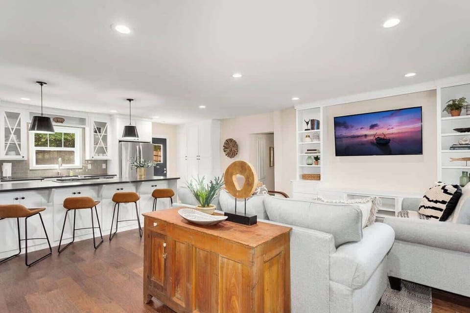 Here, you'll find our over-stuffed sofa and love seat, midcentury modern-inspired chairs, driftwood coffee table, Smart TV and stunning built-in shelves.