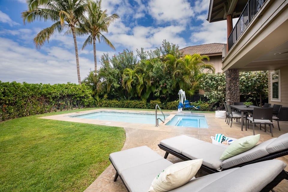 Your private pool and spa, surrounded by lush tropical landscaping.
