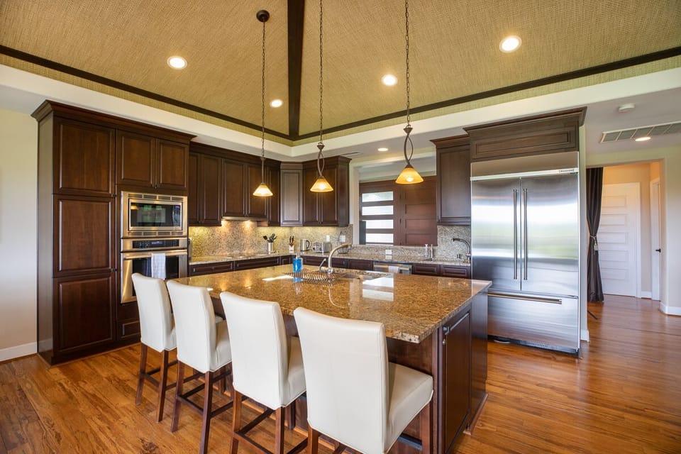 Granite island with seating for four, perfect for casual meals and conversation.