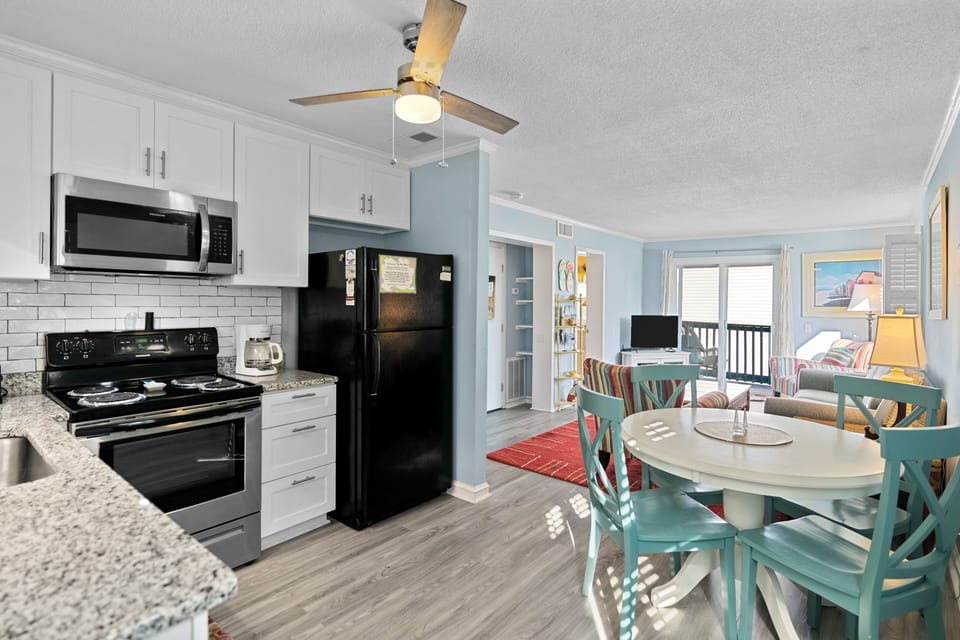 Your bright, open-plan space combines modern kitchen convenience with coastal charm—perfect for preparing meals while staying connected to your group.