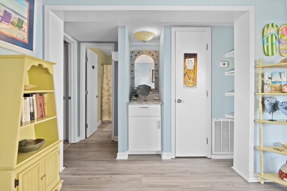Step into your charming coastal retreat with cheerful yellow built-ins and thoughtful touches throughout this bright, welcoming space.