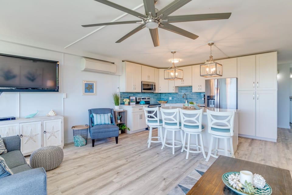 Open concept living room with a large flat screen TV. Enjoy your favorite Netflix movies and shows using smart tv.