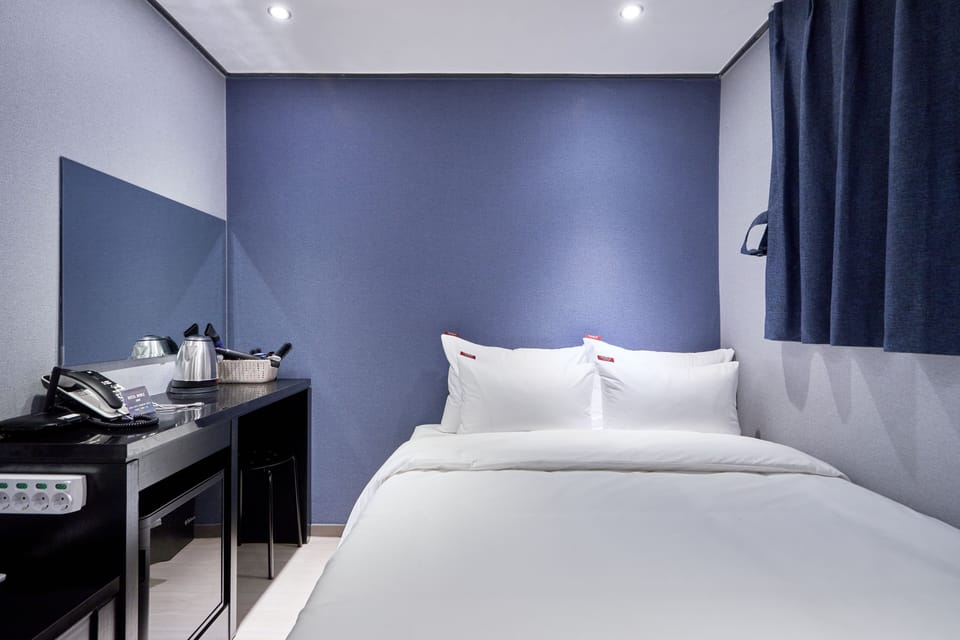 Economy Room, 1 Bedroom | Down comforters, blackout drapes, free WiFi