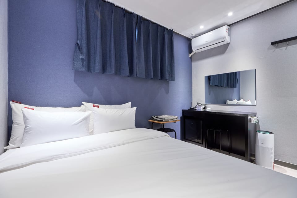 Economy Room, 1 Bedroom | Down comforters, blackout drapes, free WiFi