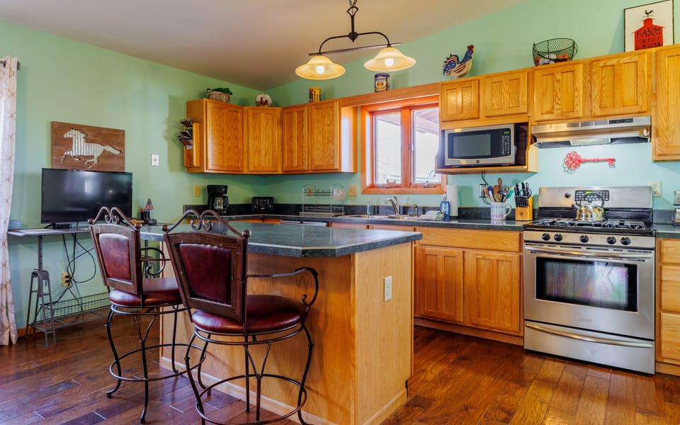Large kitchen with breakfast bar makes a great space to gather and plan the next day's adventure