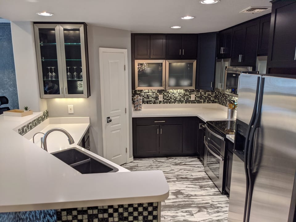 Fully stocked kitchen with custom cabinet lighting and walk in pantry. 