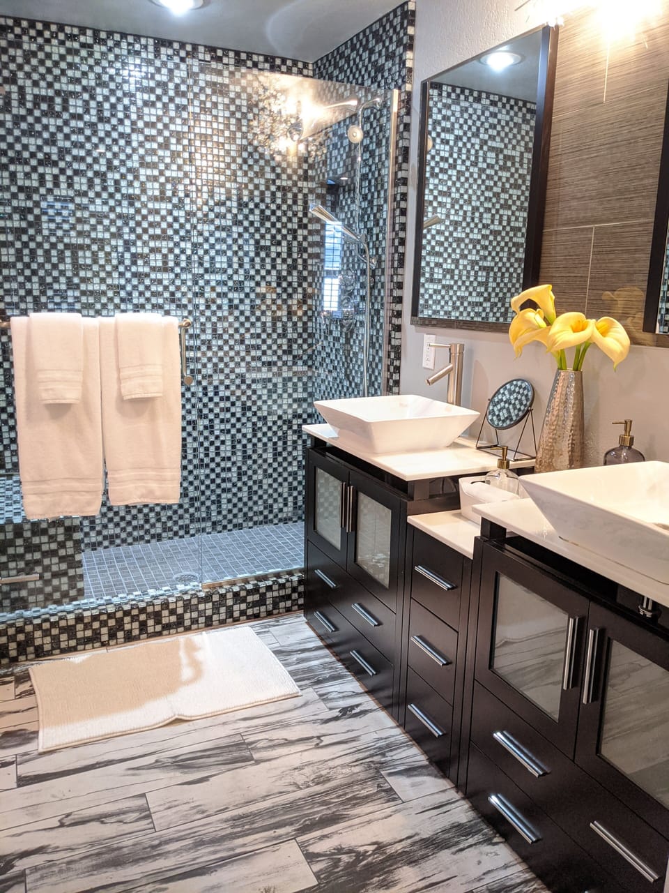 Master bathroom features double sinks, tile shower, & separate toilet room.