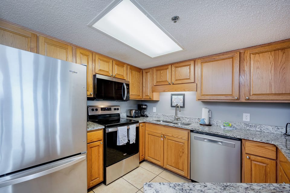 Create delicious meals together in the granite kitchen, where warm hues invite culinary creativity and family fun