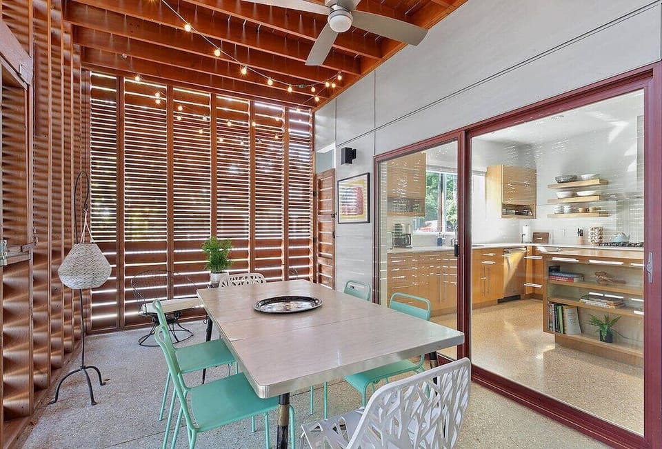 Bring your meals outside! The second of our home's 3 outdoor living spaces! Enjoy a beautiful indoor-outdoor patio space attached to the home's kitchen. Behind the outdoor dining table enjoy 2 side chairs for sipping morning coffee or evening wine.