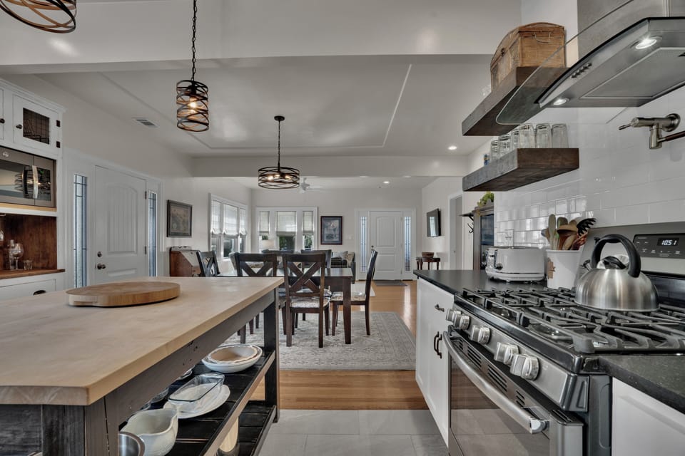Open concept kitchen, dining and living room areas.