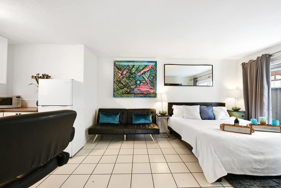 King bed next to the futon leather couch