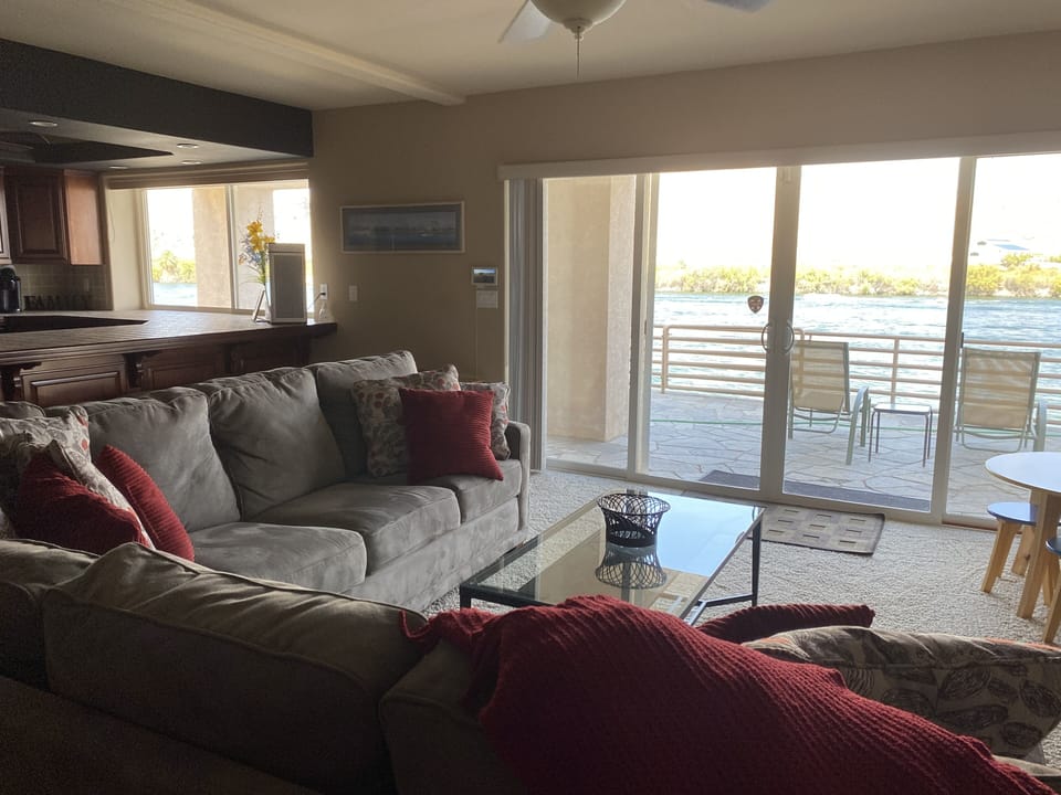living room with large sleeper sectional and river views.
