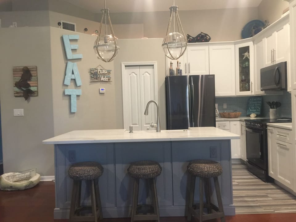 large breakfast bar and open concept kitchen to living room