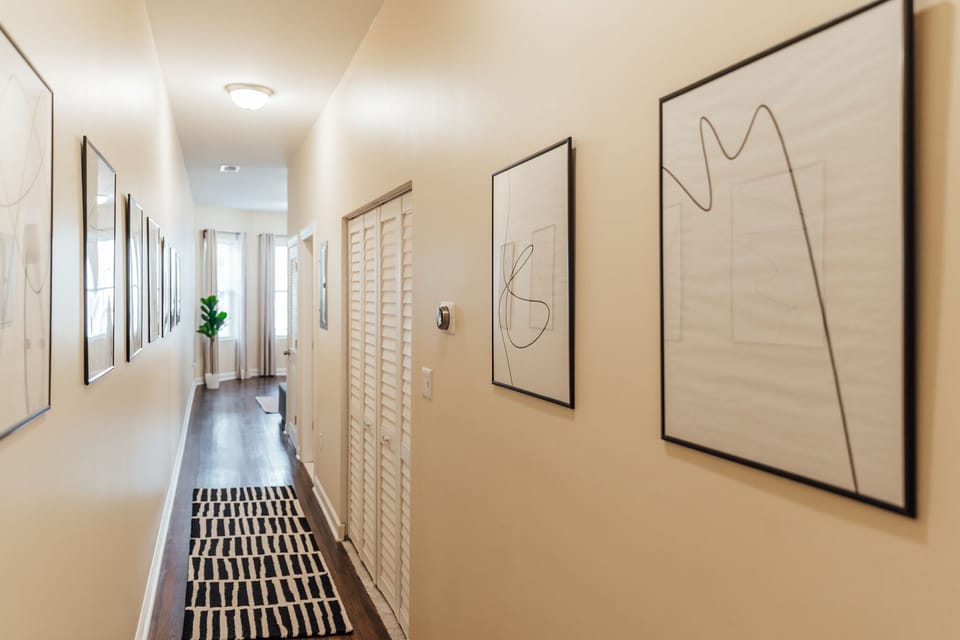 Hallways leads to the 3rd bedroom, 2nd bathroom and kitchen space