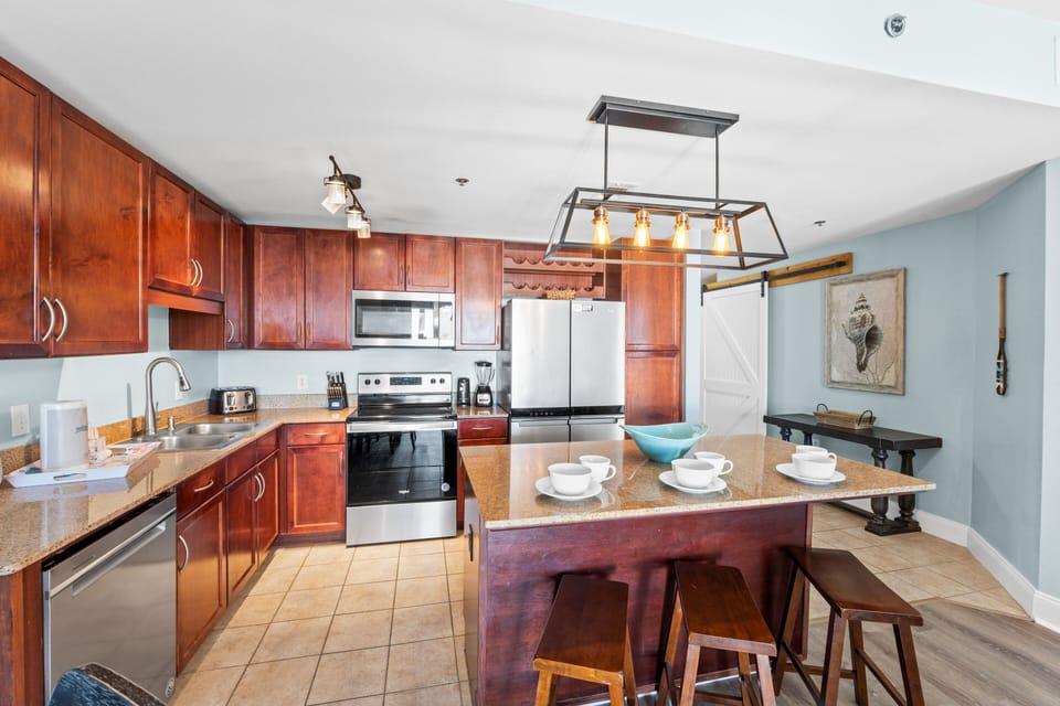 Fully Stocked Kitchen with Island Bar Seating