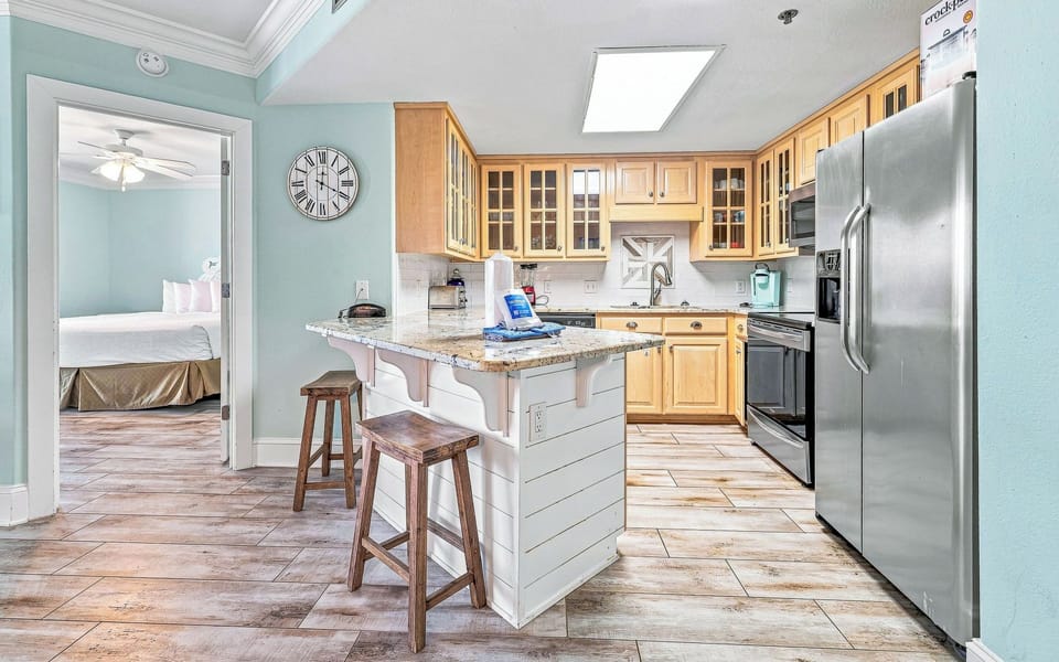 Bright cabinetry complements the spacious countertops, featuring modern appliances, Keurig and a coffee maker
