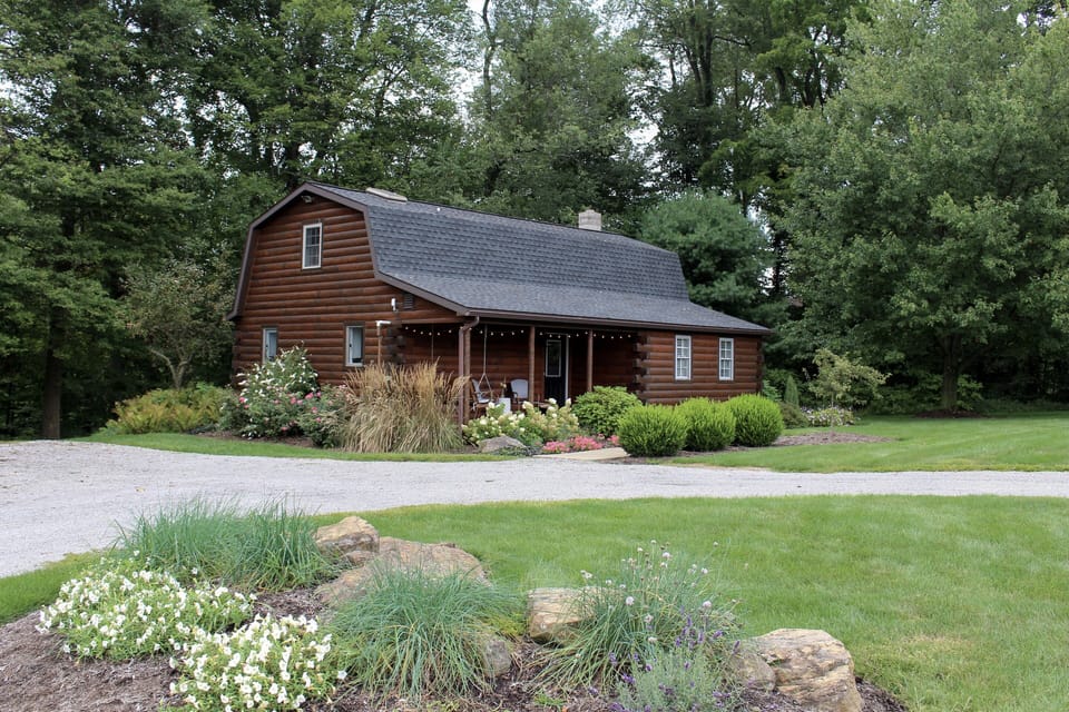 The Cabin nestled against a wooded area...