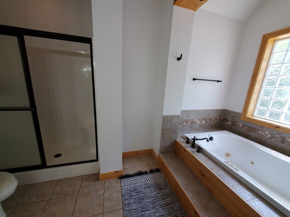 Master Bathroom has a walk-in shower and jetted bath tub.