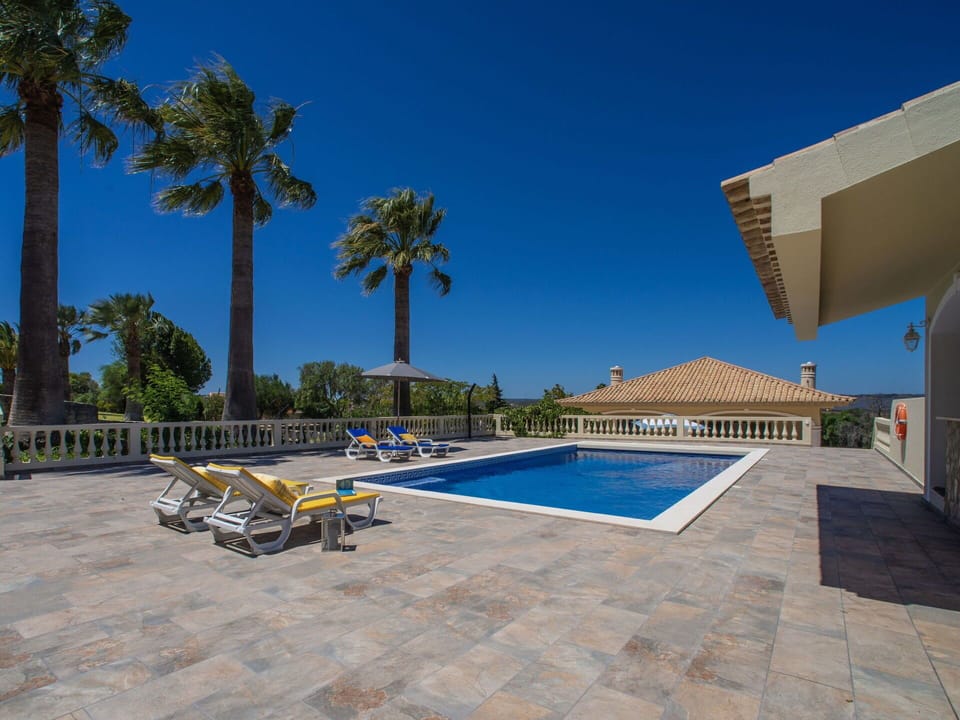 Sky, Property, Building, Azure, Shade, Swimming Pool, Outdoor Furniture, Plant, Tree, Urban Design