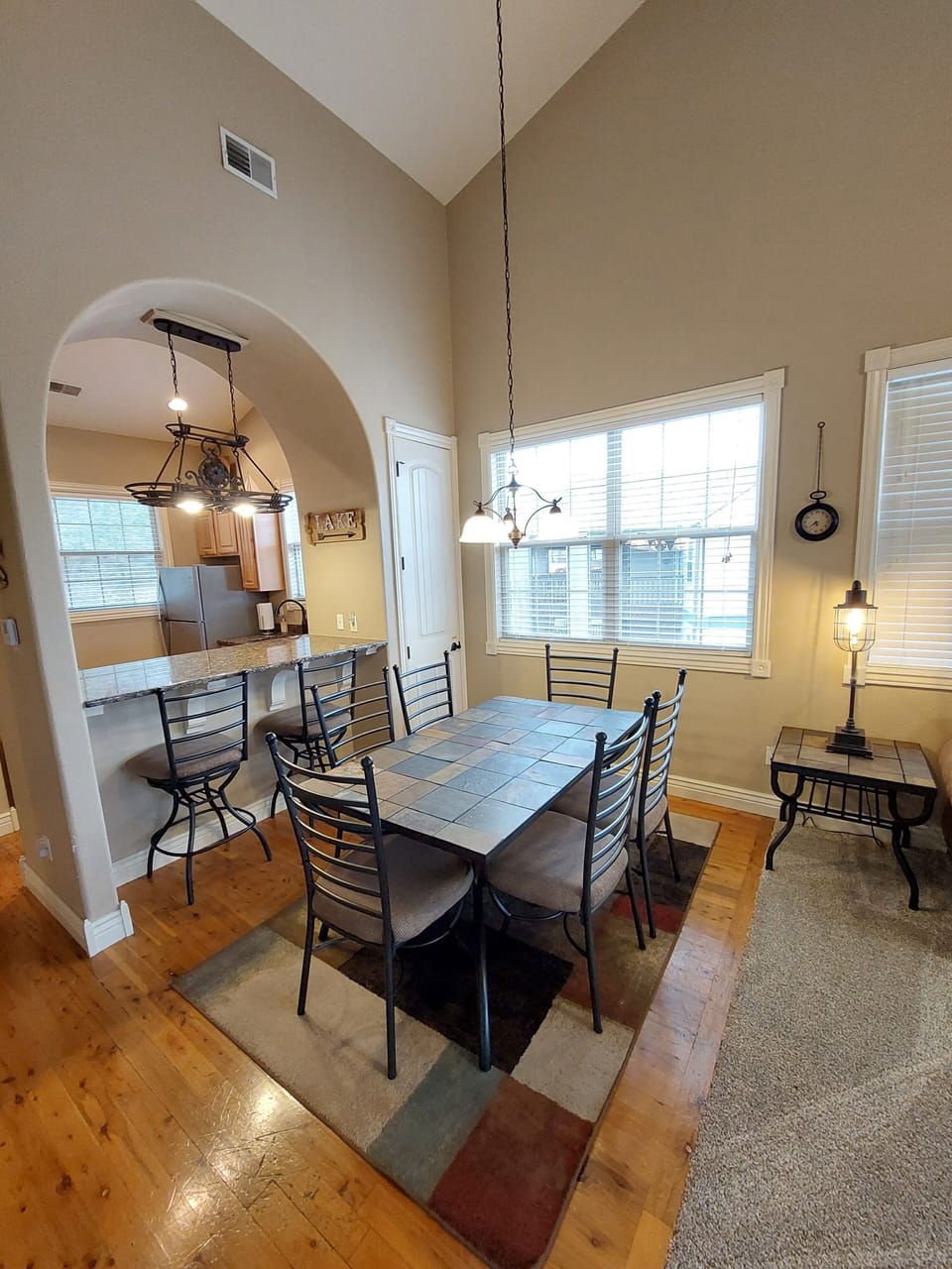 Dining table, accent lighting, & breakfast bar next to the full-sized kitchen!