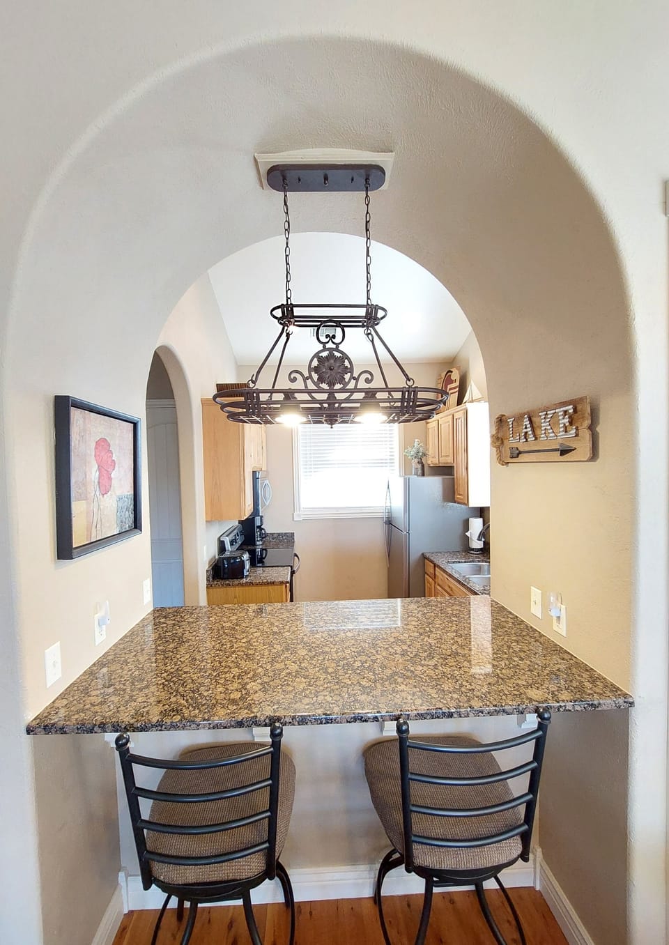Breakfast bar, tall chairs, gorgeous lighting and decor!