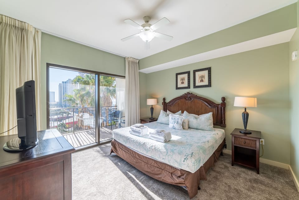 The master bedroom features a king sized bed with luxurious linens and oh-so soft pillows