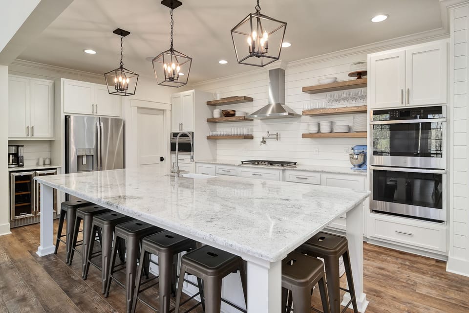 Kitchen has a double oven and 5 burner range with power-boil setting