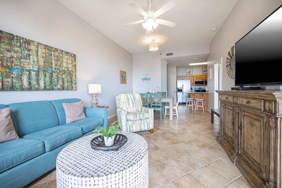Unwind in the bright living space with a queen sleeper sofa, stylish decor, and a large TV