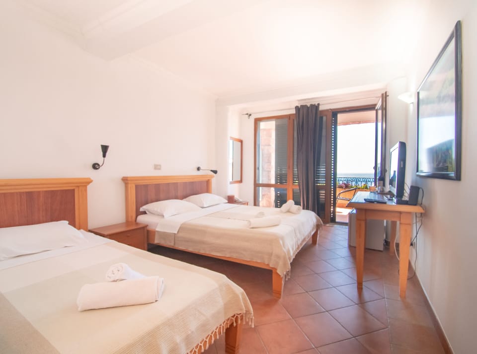 Standard Triple Room, Balcony, Partial Ocean View | In-room safe, soundproofing, iron/ironing board, WiFi