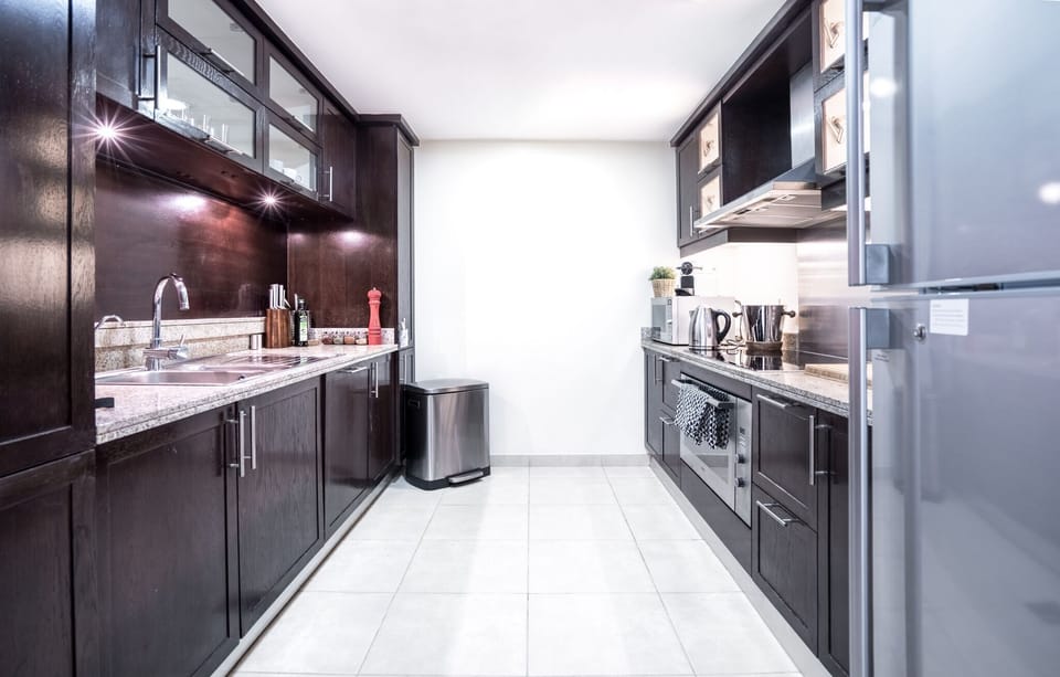 Apartment, 4 Bedrooms | Private kitchen | Full-size fridge, microwave, oven, stovetop