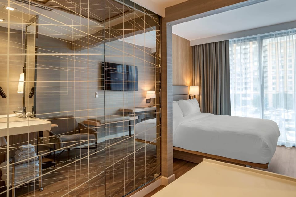 Premium bedding, desk, laptop workspace, iron/ironing board