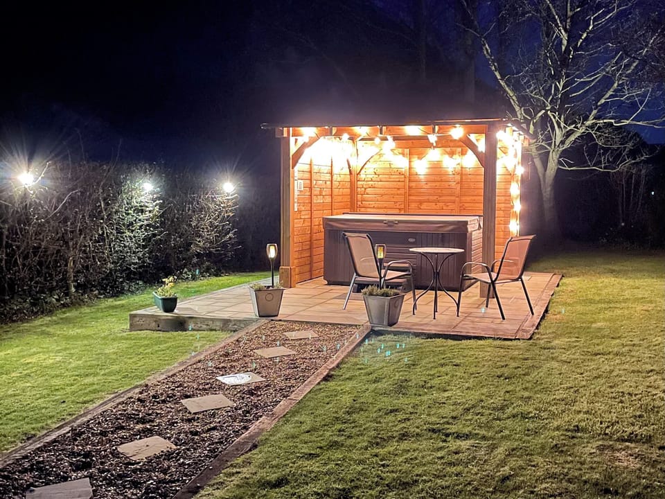 Garden at night with covered hot tub | Herrock View, Knill, near Presteigne