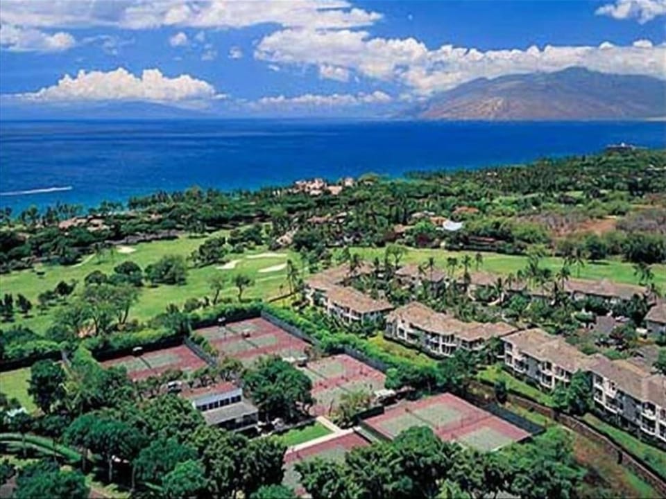Aerial view of Grand Champions with adjoining tennis courts and golf course.