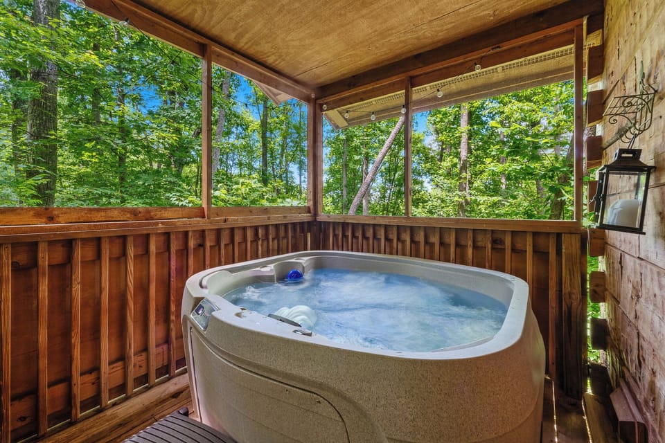 Relax in a private hot tub on the screened-in deck, surrounded by trees and fresh mountain air—ideal for unwinding after exploring.