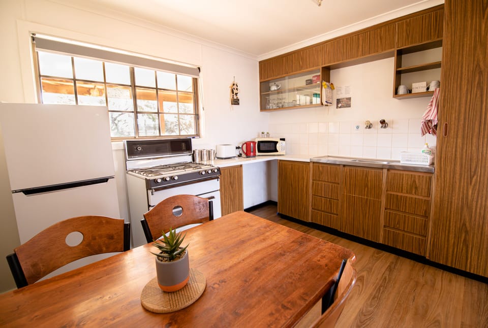 Acacia Cottage | Private kitchen | Fridge, oven, stovetop, cookware/dishes/utensils