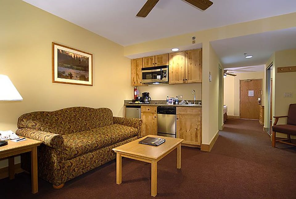 Living room with queen pullout and resort kitchen, Suite side.