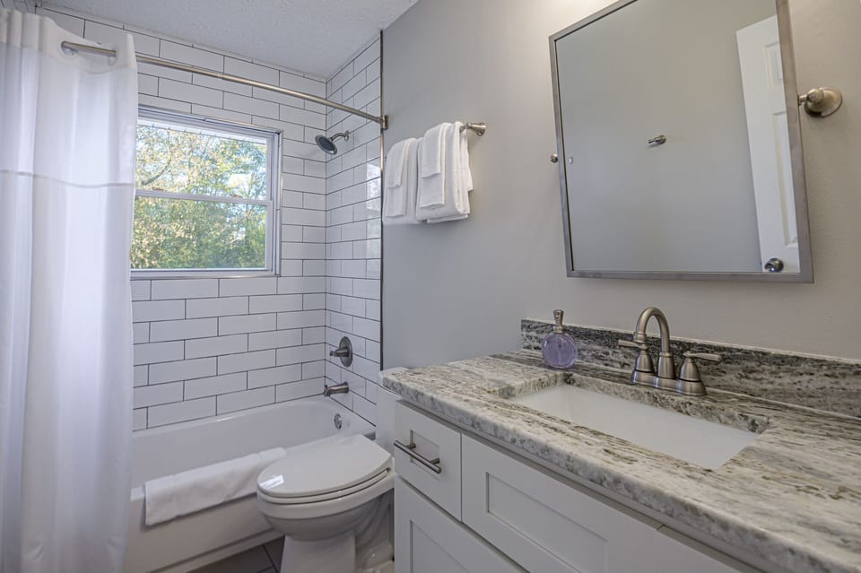 Hallway bathroom with a shower tub combo.