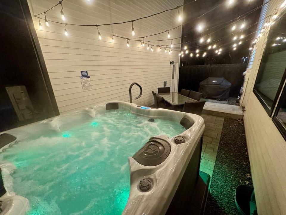 Back courtyard area with hot tub and BBQ