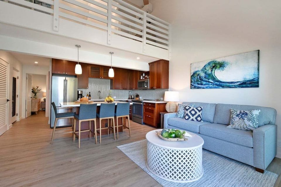 Spacious open-concept living area with modern kitchen and cozy seating