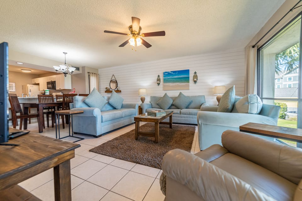 The open floor plan great room offers a queen sized sofa sleeper, matching loveseat, oversized chair, and leather recliner