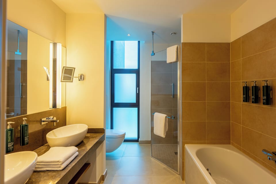 King One Bedroom Suite | Bathroom | Combined shower/tub, deep soaking tub, free toiletries, hair dryer