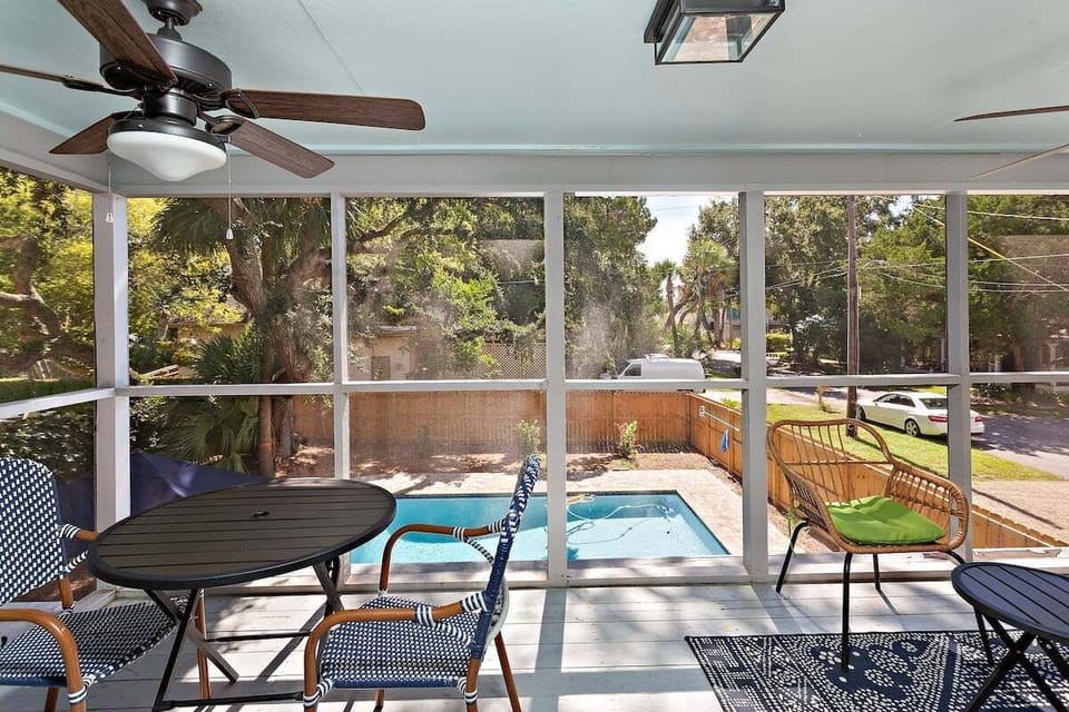 Balcony off primary bedroom with seating and view of the pool