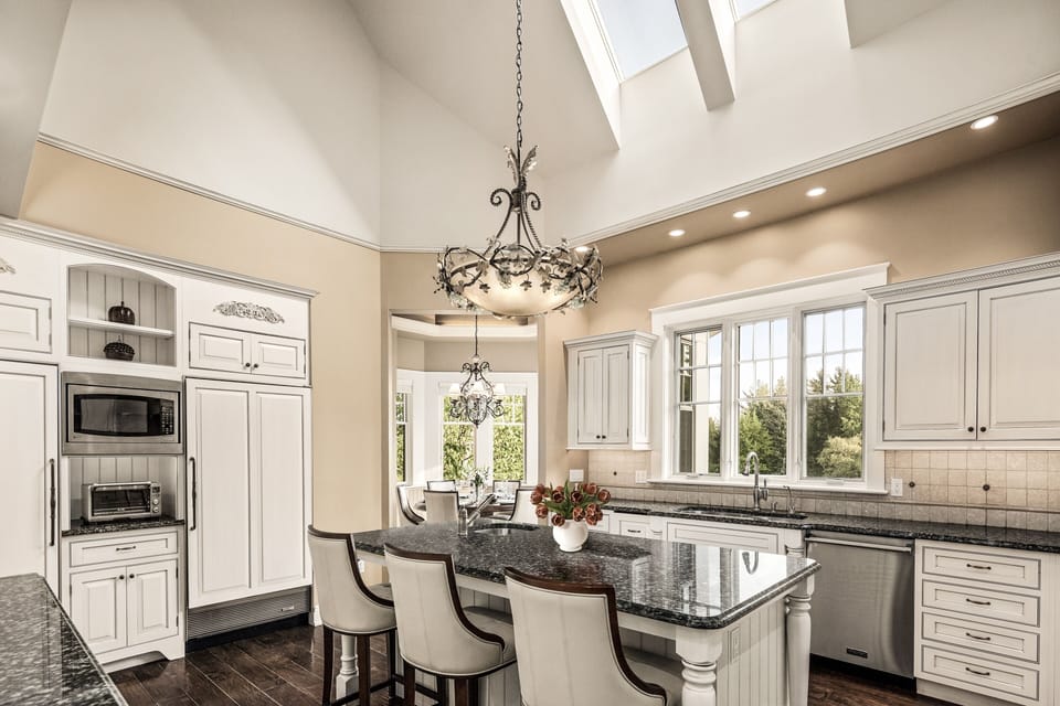 Kitchen seats 9 w/ vaulted ceilings, skylights, and adjoining breakfast nook
