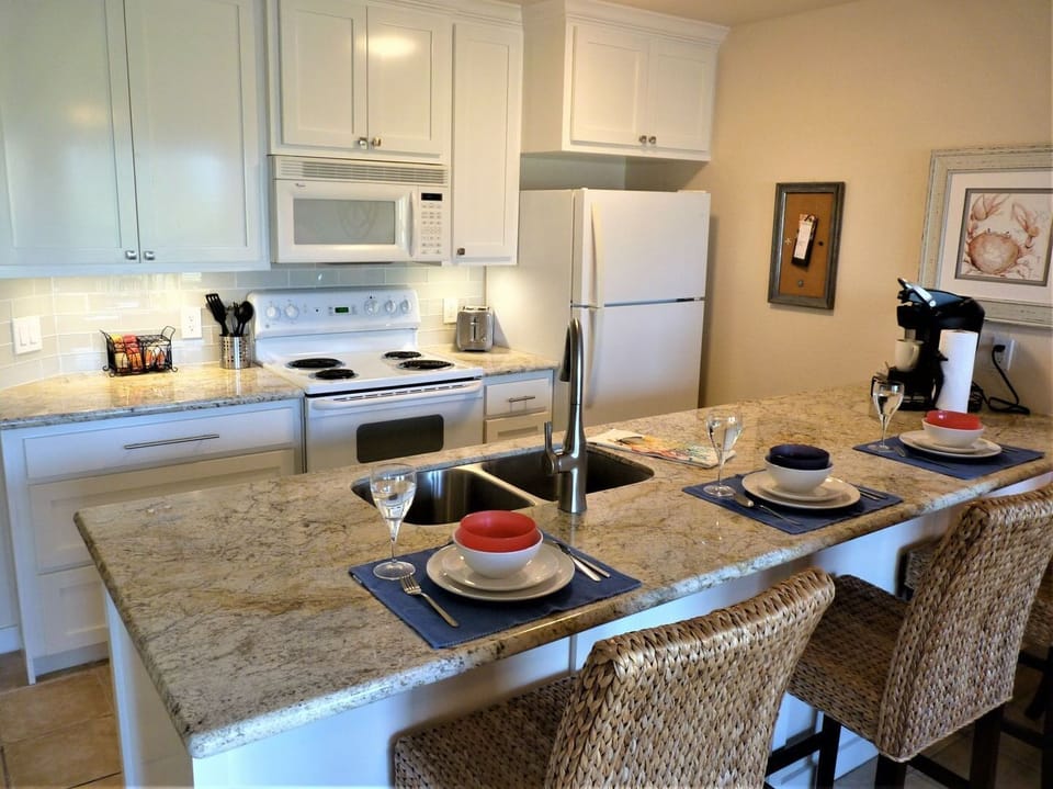 Beautifully upgraded counter-height granite, custom cabinets, and counter space. You'll love the storage in this updated kitchen!