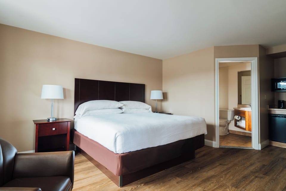 Premium bedding, desk, laptop workspace, blackout drapes