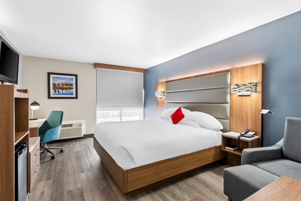 Premium bedding, desk, laptop workspace, blackout drapes